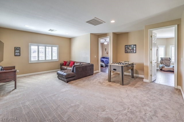 living room with light carpet and a wealth of natural light