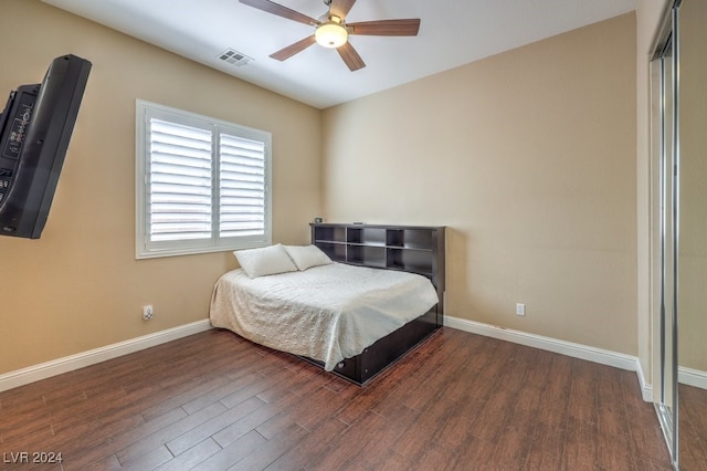 bedroom featuring ceiling fan and dark wood-type flooring