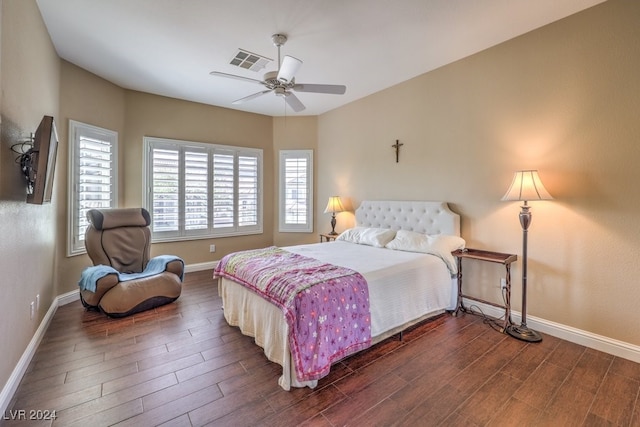 bedroom with dark hardwood / wood-style floors and ceiling fan