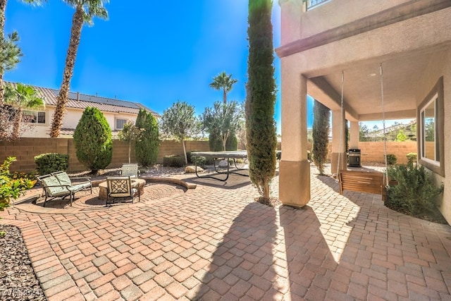 view of patio / terrace featuring an outdoor fire pit