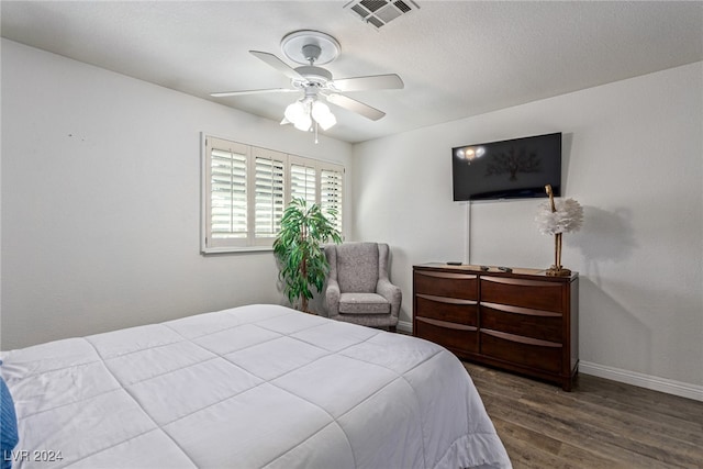 bedroom featuring ceiling fan and dark wood-type flooring