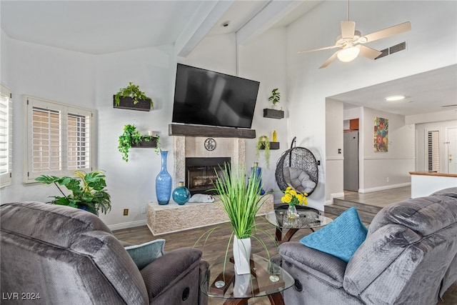 living room featuring a tiled fireplace, high vaulted ceiling, hardwood / wood-style flooring, and ceiling fan