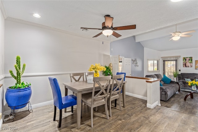 dining room with hardwood / wood-style floors, ceiling fan, and vaulted ceiling