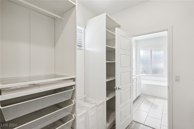 spacious closet featuring light tile patterned flooring