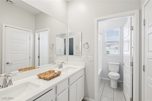 full bathroom featuring tub / shower combination, vanity, and toilet