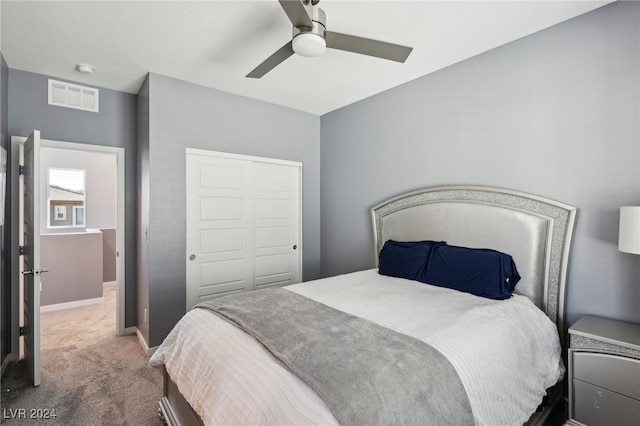 bedroom with ceiling fan, a closet, and carpet