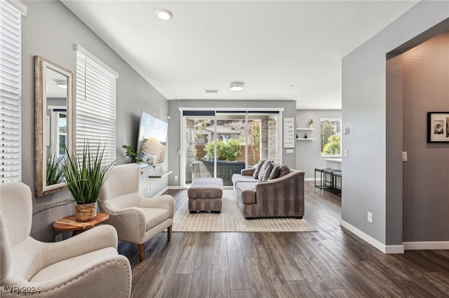 living room with dark hardwood / wood-style flooring