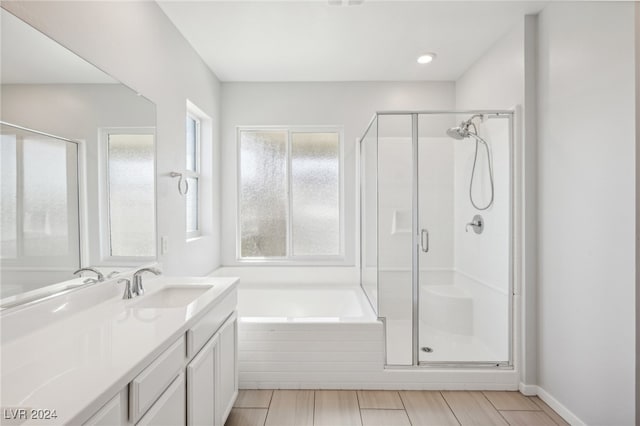 bathroom with independent shower and bath and vanity