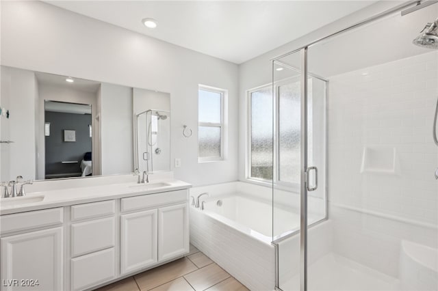 bathroom featuring vanity, plus walk in shower, and tile patterned flooring