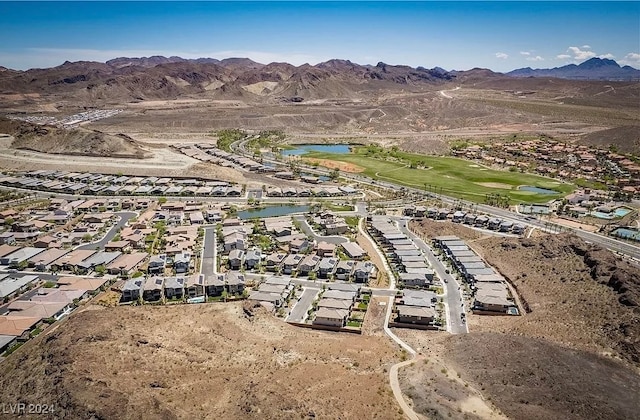 birds eye view of property with a water and mountain view