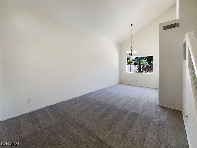 empty room featuring carpet, an inviting chandelier, and high vaulted ceiling