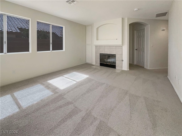 unfurnished living room featuring a fireplace and light carpet