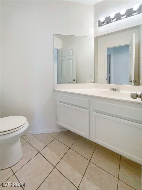 bathroom with tile patterned floors, vanity, and toilet