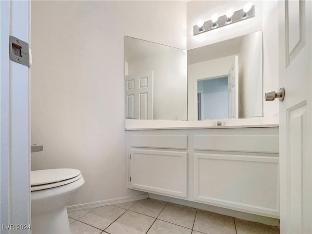 bathroom with tile patterned floors, vanity, and toilet