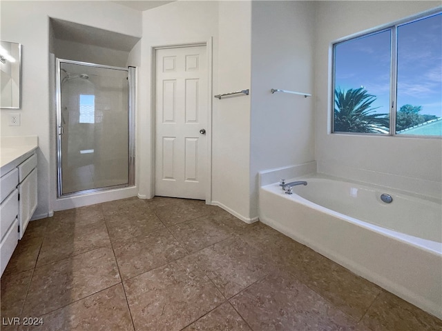 bathroom with independent shower and bath and vanity