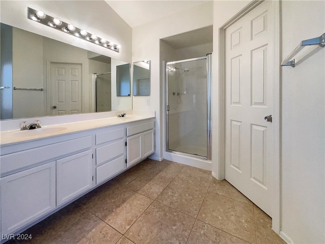 bathroom with tile patterned floors, an enclosed shower, and vanity