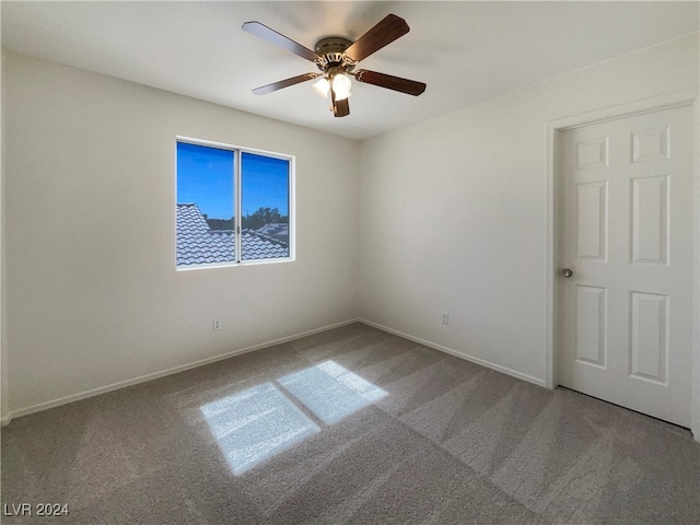 spare room featuring carpet floors and ceiling fan