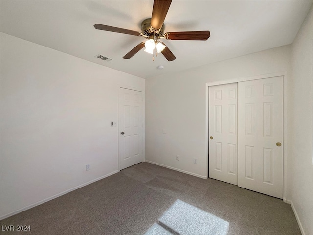 unfurnished bedroom with ceiling fan, a closet, and carpet flooring