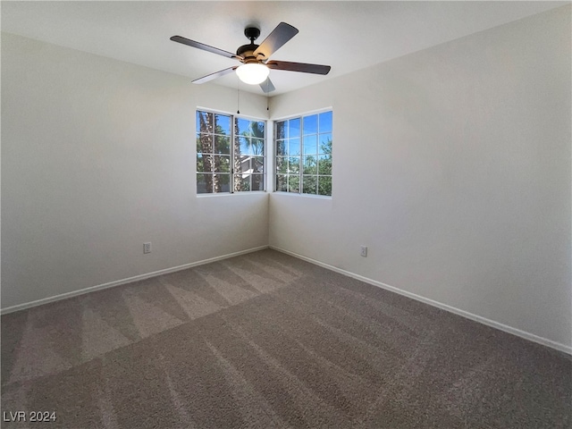 empty room with ceiling fan and carpet