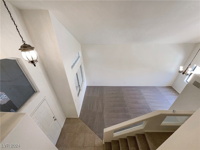 stairway featuring a high ceiling and tile patterned floors