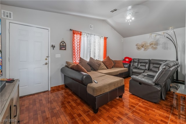 living room with dark hardwood / wood-style floors, ceiling fan, and lofted ceiling