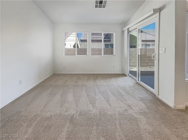 unfurnished room featuring carpet and plenty of natural light