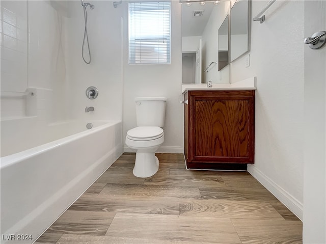 full bathroom featuring wood-type flooring, shower / tub combination, vanity, and toilet