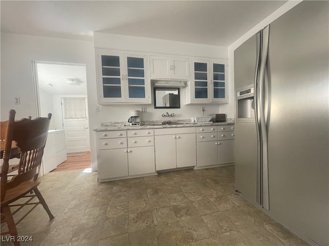 kitchen with white cabinets and stainless steel refrigerator with ice dispenser