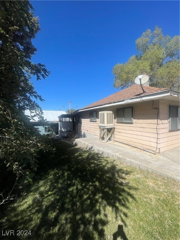 view of property exterior with a lawn