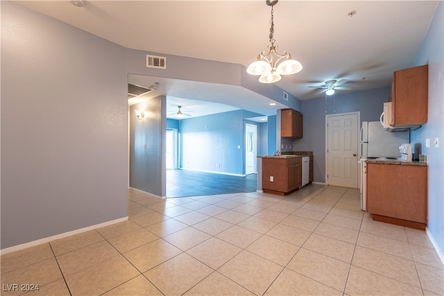 kitchen featuring ceiling fan with notable chandelier, light tile patterned floors, and white appliances