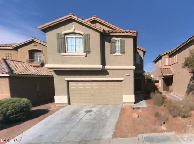 mediterranean / spanish-style home featuring a garage