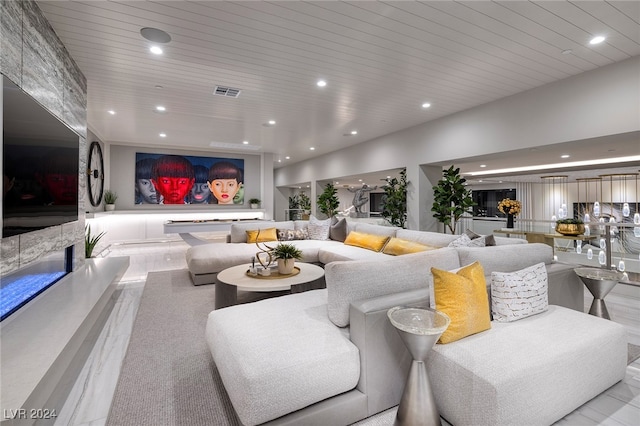 living room with wooden ceiling and a fireplace