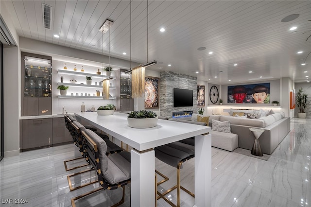 dining room featuring bar and wooden ceiling