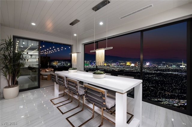 tiled dining area with wooden ceiling