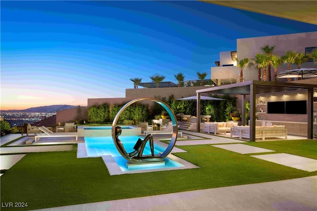 pool at dusk with outdoor lounge area, a yard, a pergola, and a patio