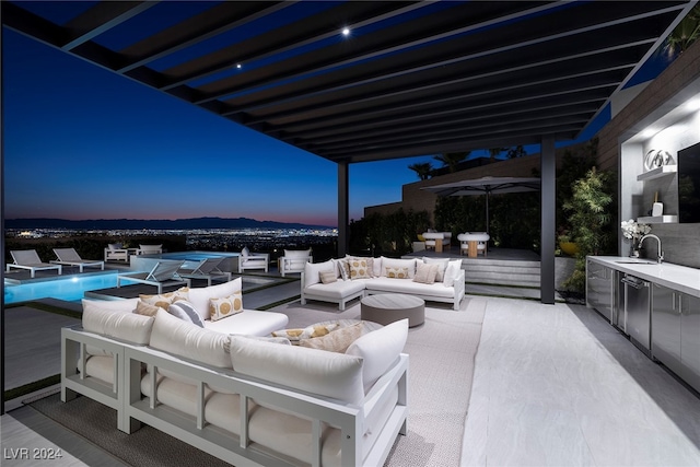 view of patio with outdoor lounge area and sink