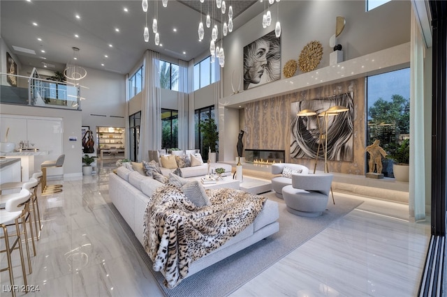 living room with an inviting chandelier and a towering ceiling