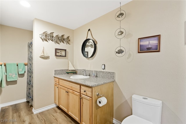 bathroom featuring hardwood / wood-style floors, vanity, and toilet