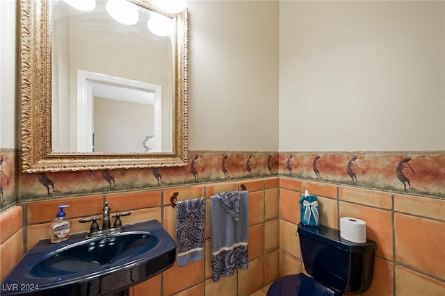 bathroom with tile walls and sink