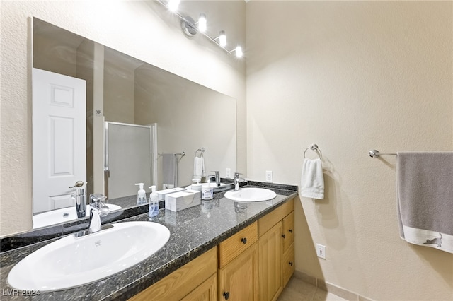 bathroom featuring vanity and an enclosed shower