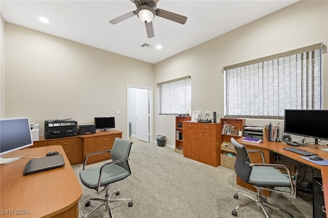 carpeted home office featuring ceiling fan and a wealth of natural light