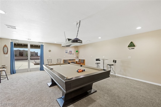 recreation room featuring a textured ceiling, light colored carpet, and billiards