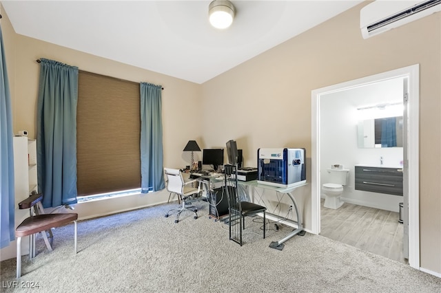 office area with an AC wall unit and wood-type flooring