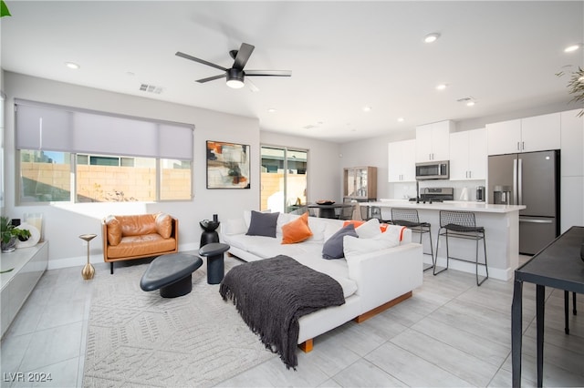 tiled living room with ceiling fan