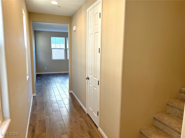 hallway with hardwood / wood-style floors