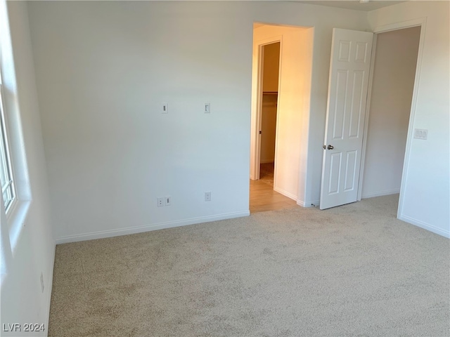 spare room featuring light colored carpet