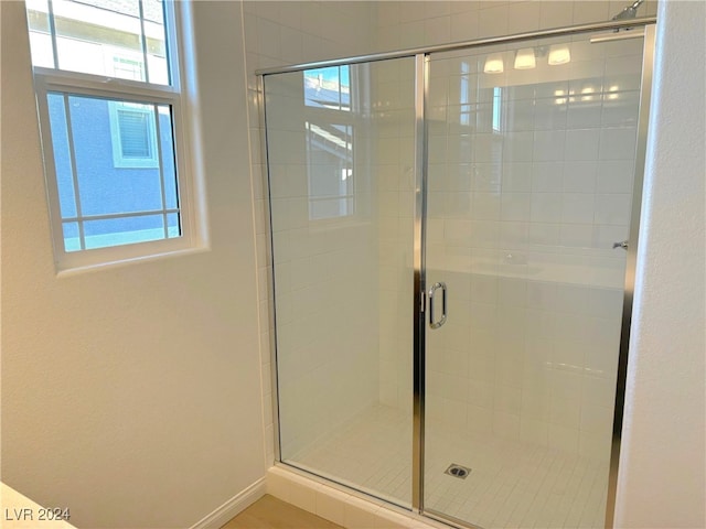 bathroom with a shower with door