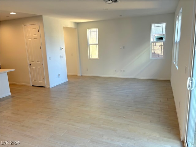 unfurnished room with light hardwood / wood-style flooring