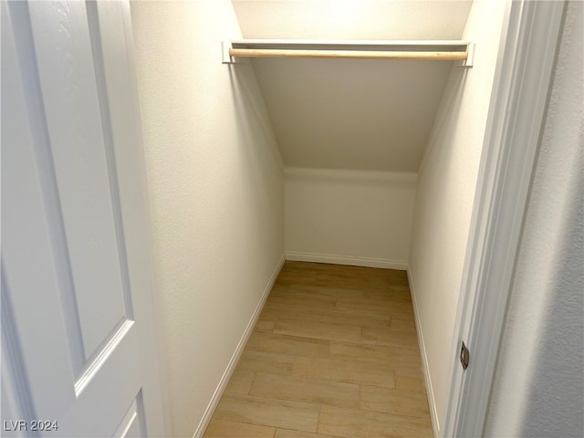 spacious closet with light hardwood / wood-style floors