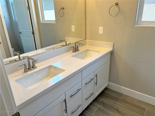 bathroom with hardwood / wood-style floors, vanity, and toilet